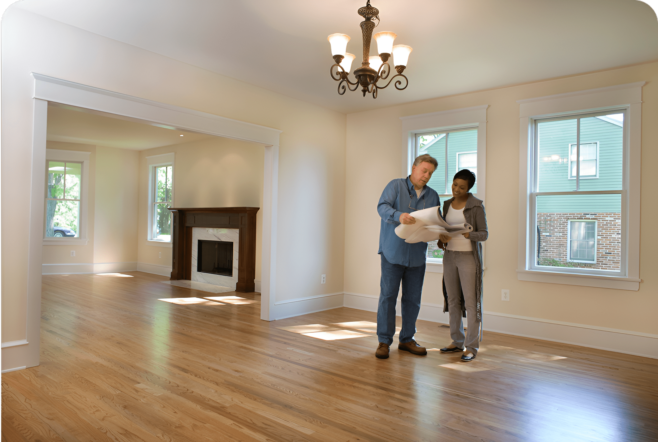 Two people reviewing plans in empty room.