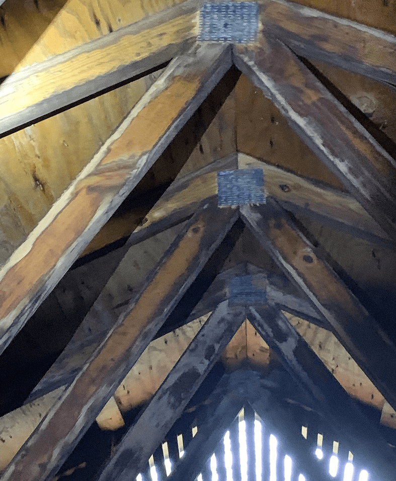 Wooden attic beams with metal connectors.