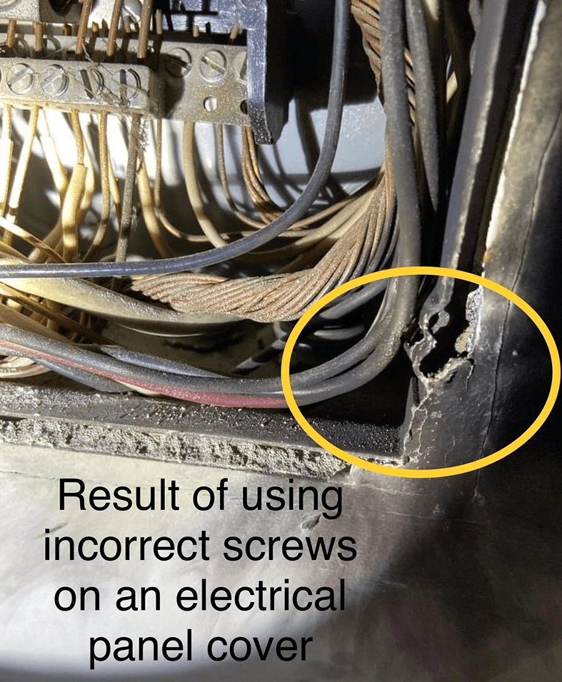 Damaged electrical panel with incorrect screws.