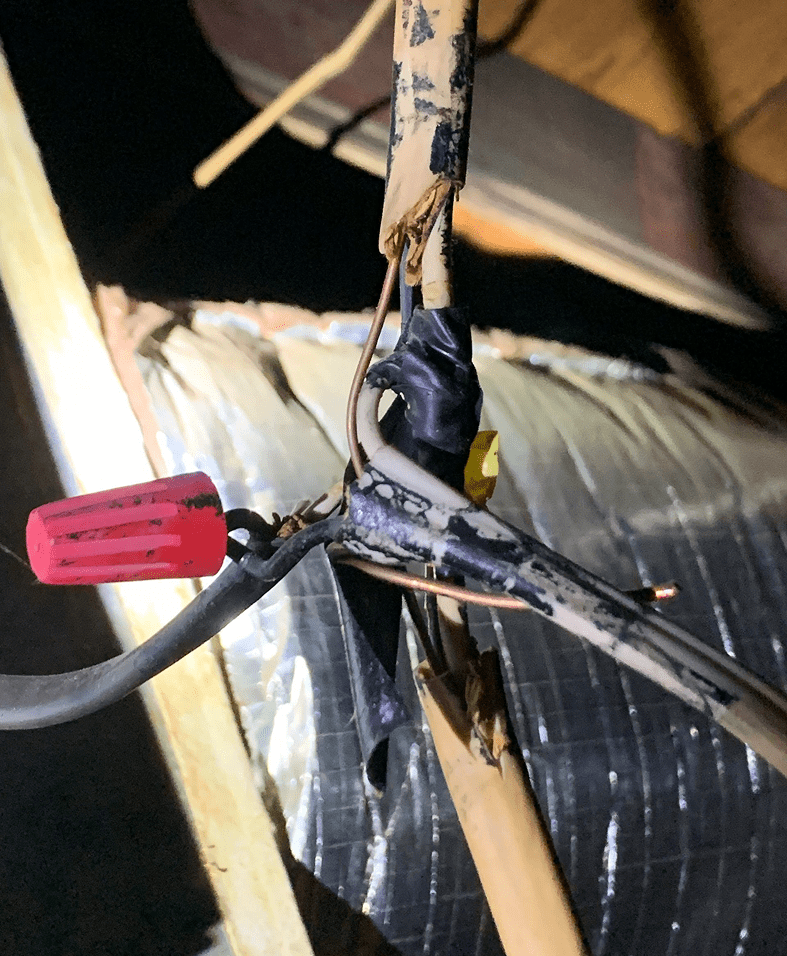 Exposed wires with electrical tape and connector.