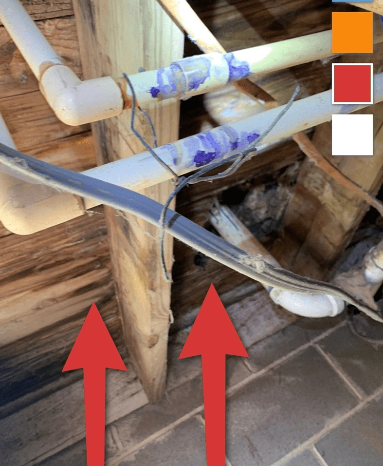 Exposed pipes with arrows indicating direction.