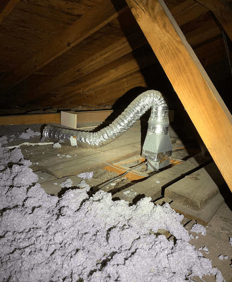 Attic with insulation and flexible ductwork.