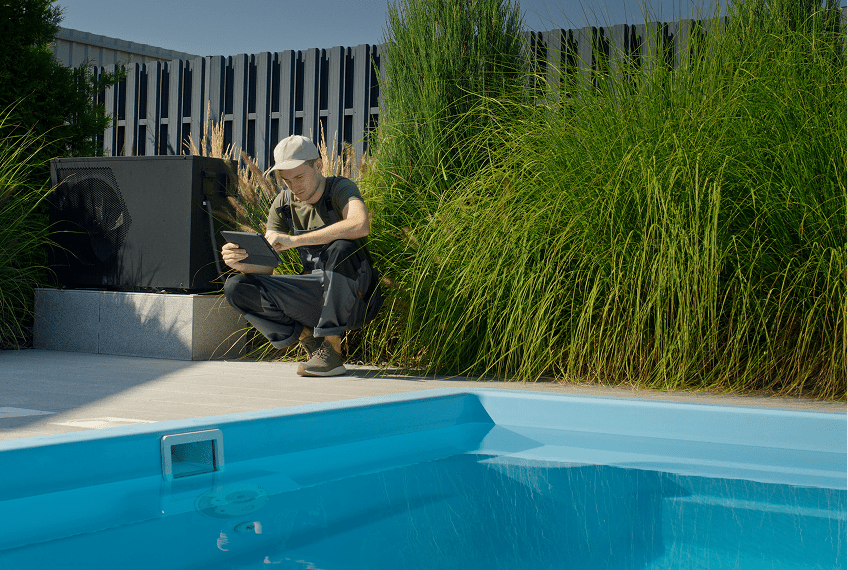 Man inspecting pool near tall grass.